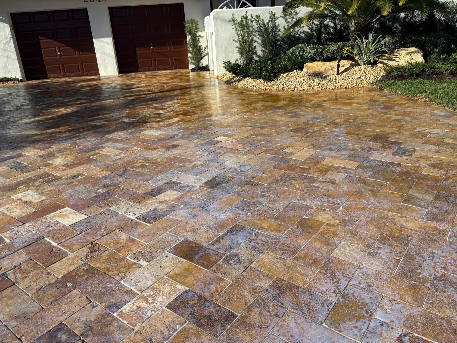 Sealed travertine paver driveway with rich amber tones
