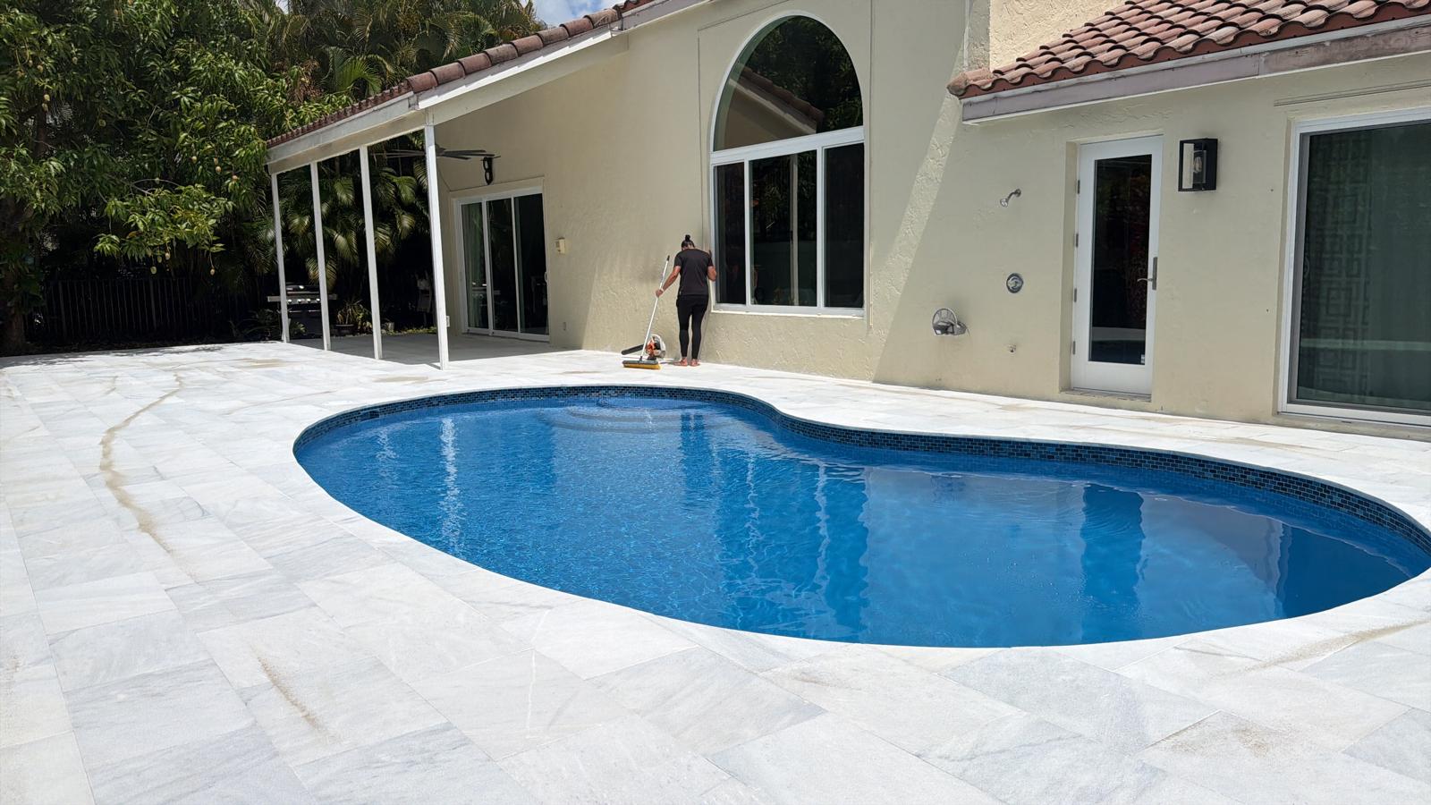 Remodeled freeform pool with new marble deck