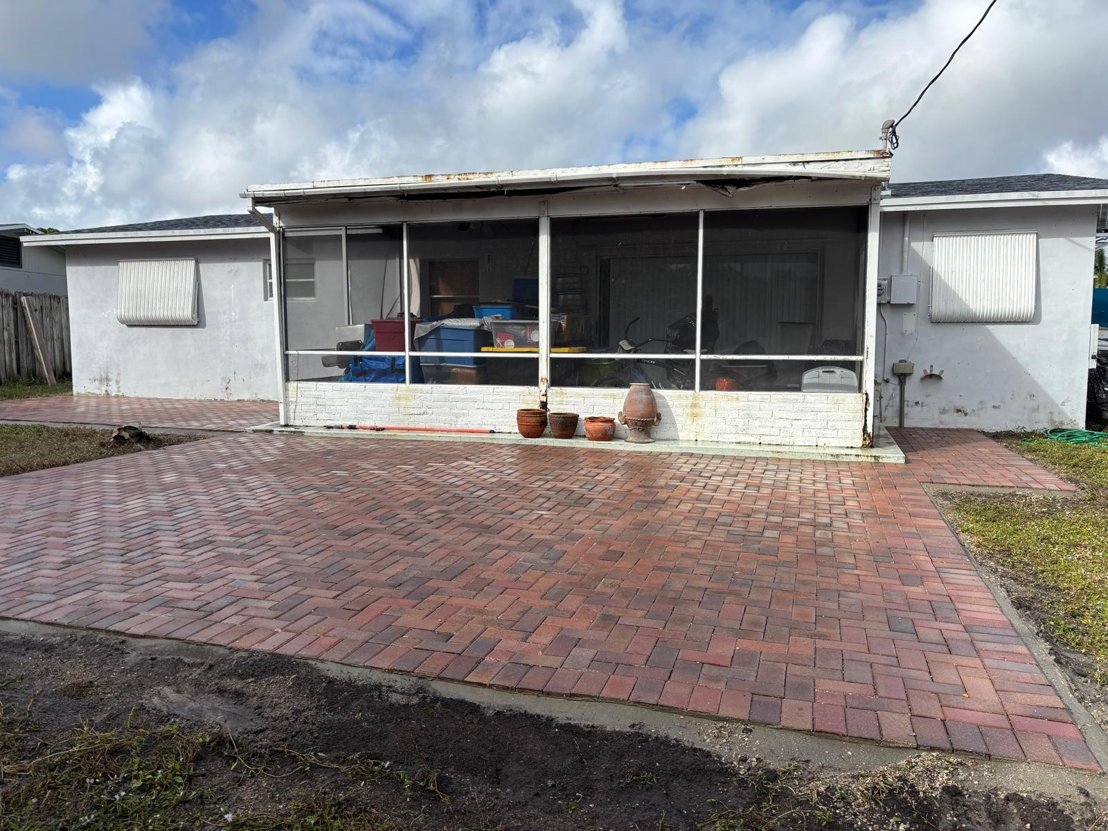 Red brick paver patio extension behind a Florida home