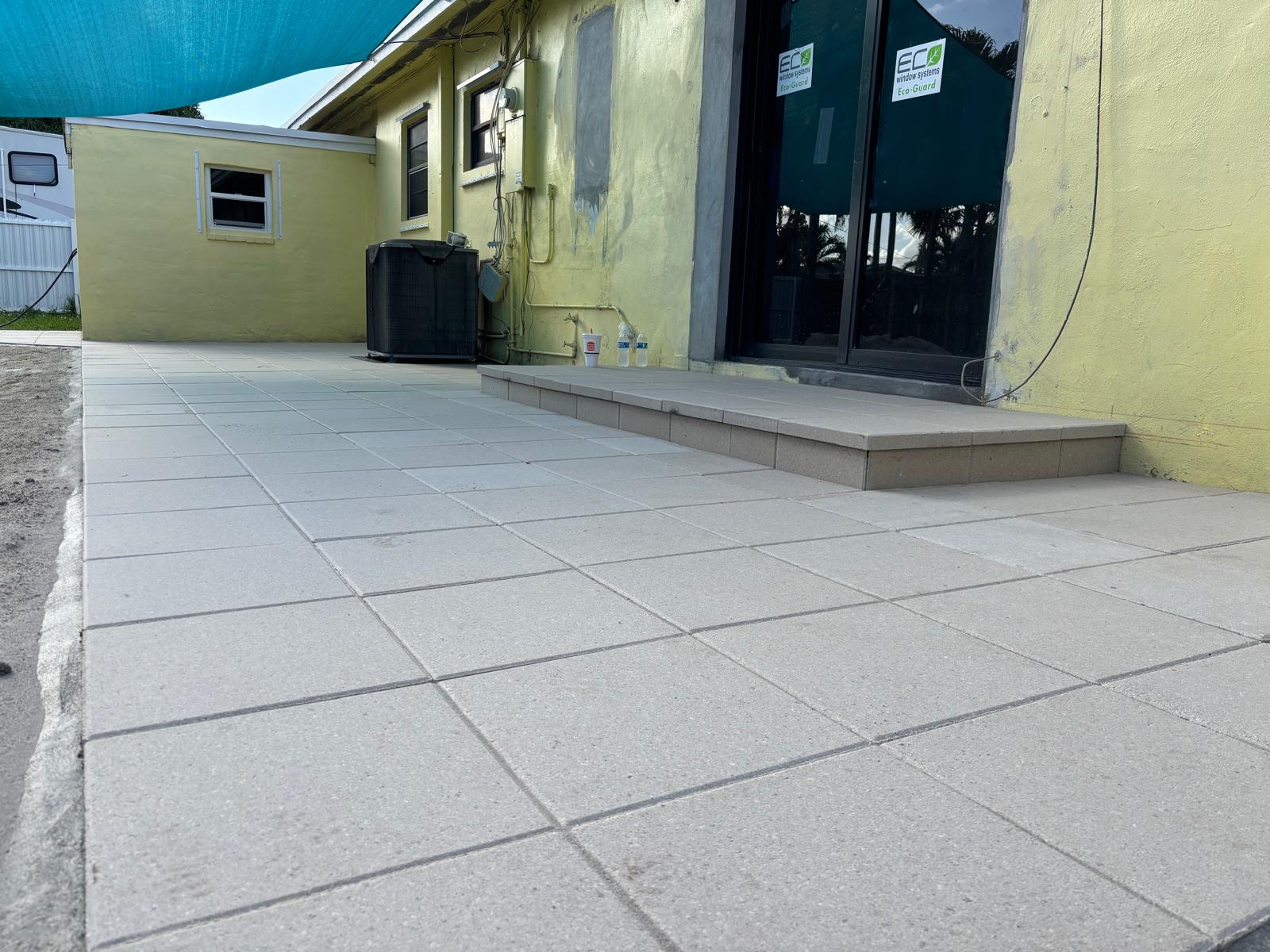 New concrete paver patio with raised step ledger