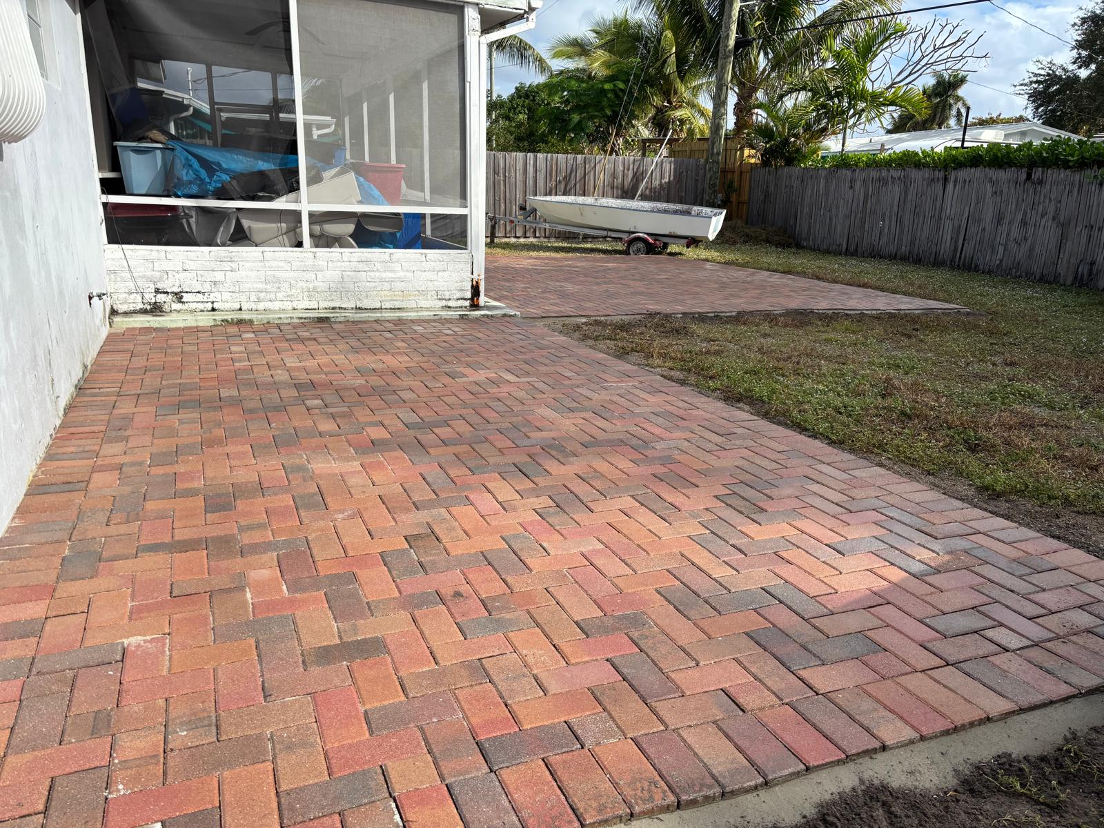 Brick paver patio extension in a South Florida backyard