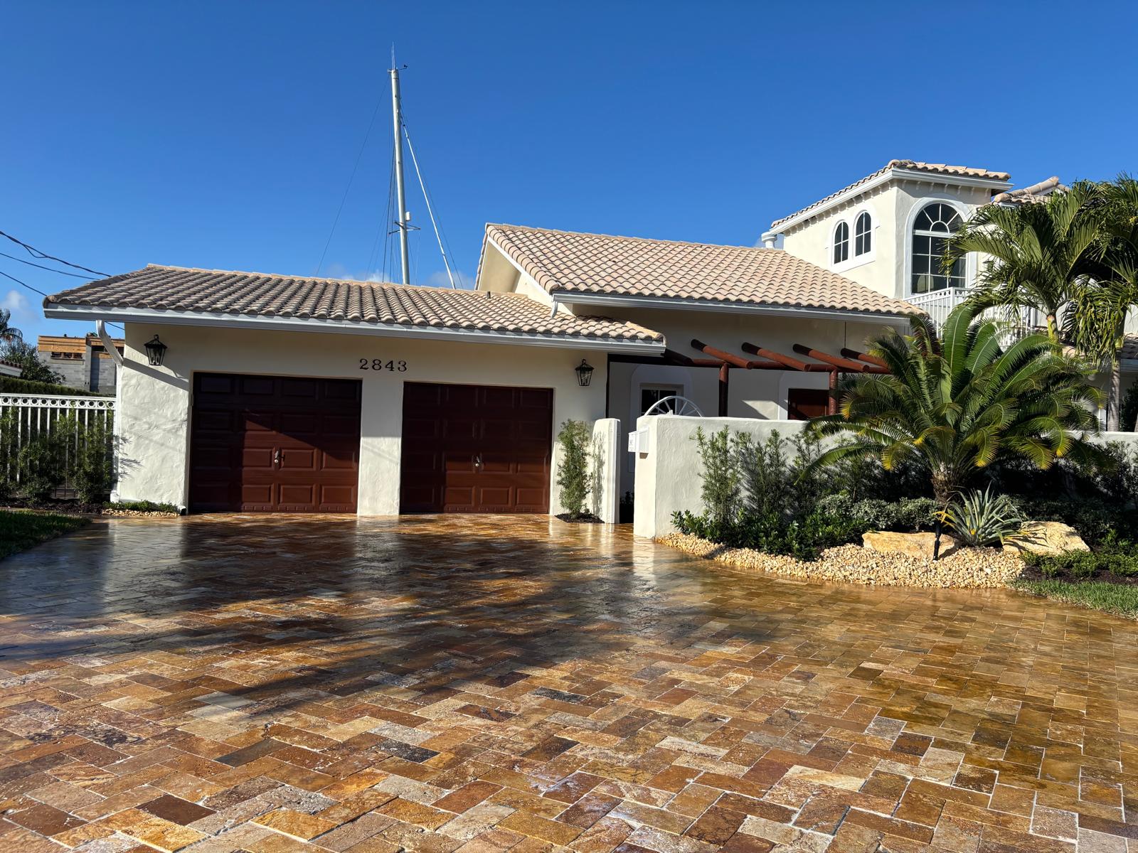Travertine paver driveway on a South Florida waterfront home